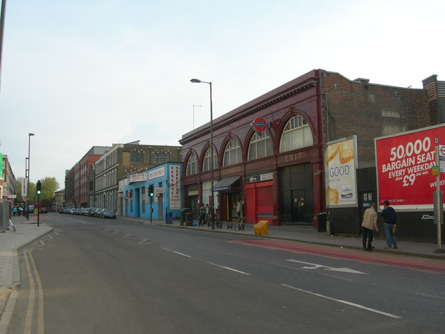 medium-sized maroon-painted station-entrance, formed as a series of five arches