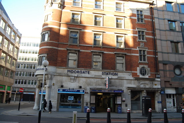 slightly grubby station entrance in street of tall, terraced office buildings