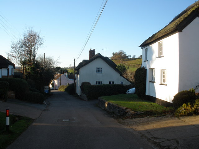 view of square white houses with hill in background