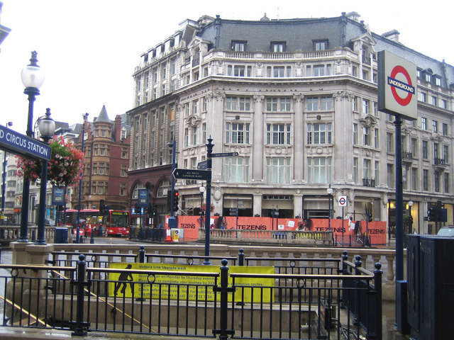 steps down to underground station entrance in the middle of a junction between broad streets of shops