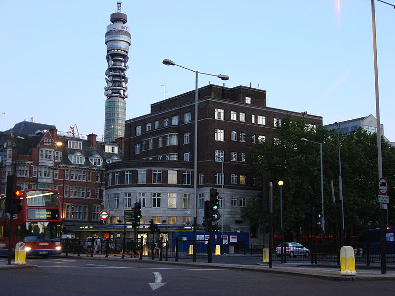 Art Deco station-entrance, with high-tech tower in background