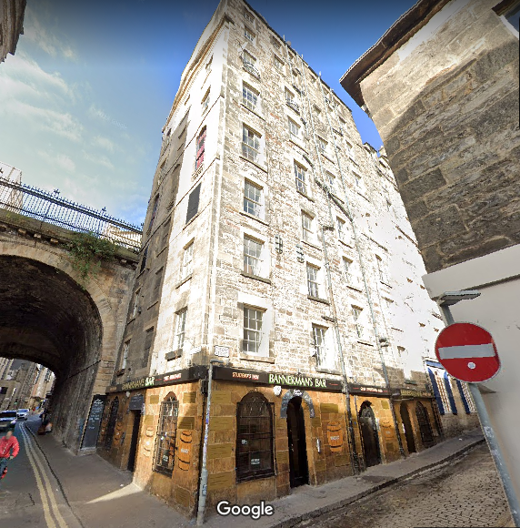 photo of Bannerman's Bar at base of eight or nine storey stone building