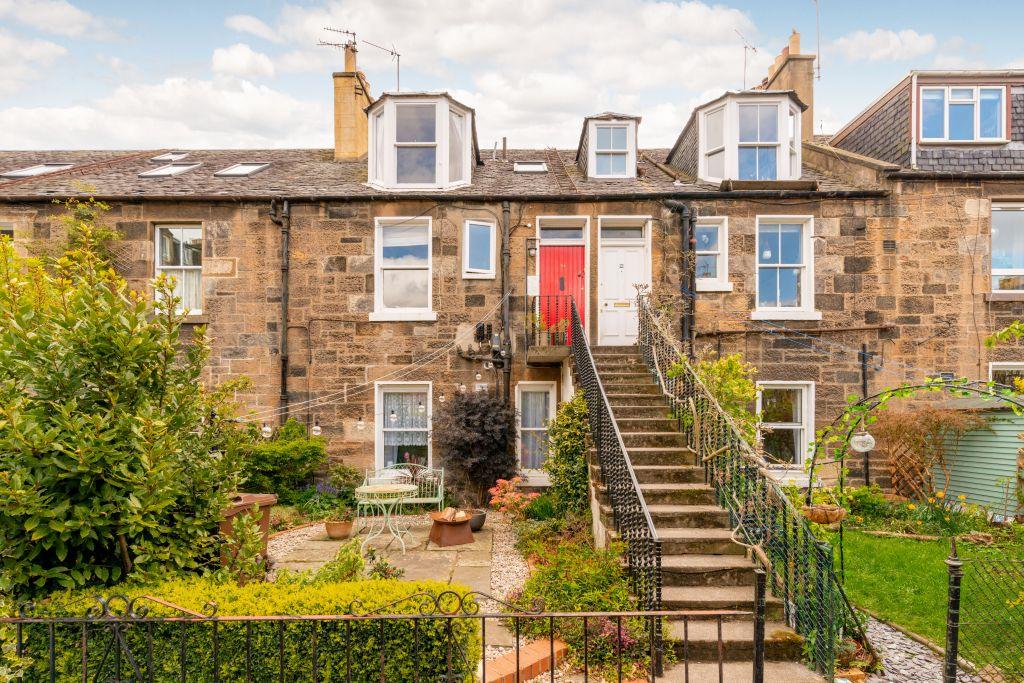 Photo of small two-storey houses with steps from the upper floor to the garden