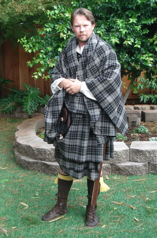 Photo of man in brown boots and grey tartan great plaid