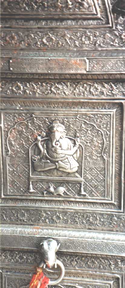 Ganesh seated with rat at his feet, embossed on silver panel