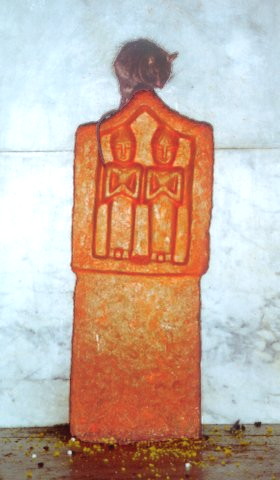 Dark-coated ship rat sitting on top of a red pillar on which simplified twin human figures are carved