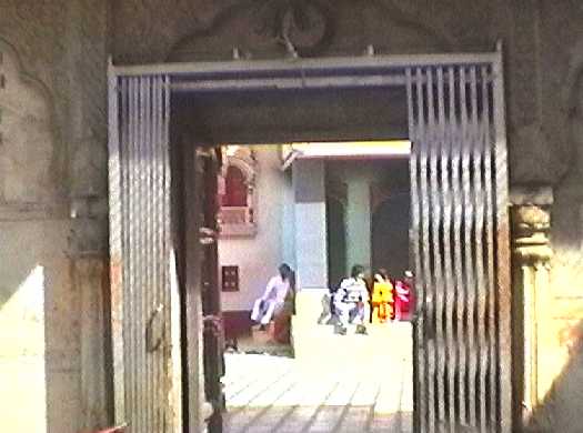 View looking out through temple entrance towards building with veranda