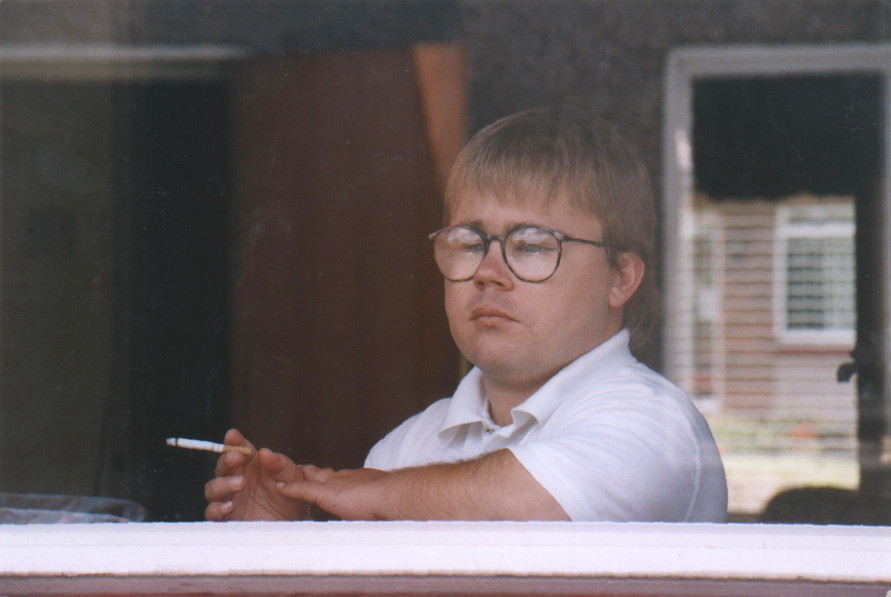 Eric Cullen seen through window, with cigarette - photo' which accompanied original Big Issue article