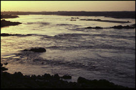 currents criss-crossing a flat silvery expanse of water