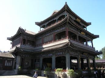 squarish three-storey pagoda with open sides, painted in soft blue-grey and pink