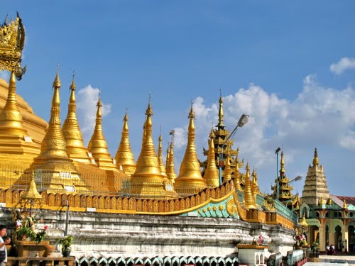 colour photo\' showing a forest of golden spires rising above an ornate stone wall