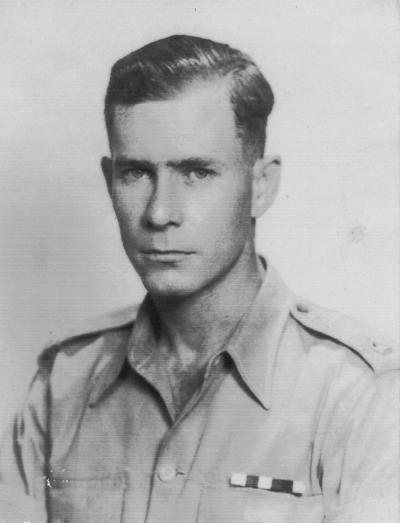 greyscale head and shoulders photo\' of a handsome, slim young man in a uniform shirt