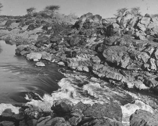 black and white photo\' of water rushing between rocks