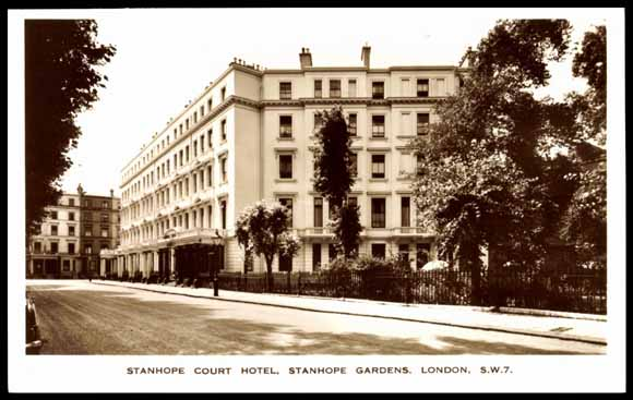 b+w image of a huge white 5-storey block Georgian or Victorian block seen corner-on, with a canopied arcade all along the front