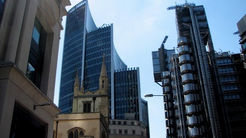 16th C church with hyper-Modernist skyscrapers behind it