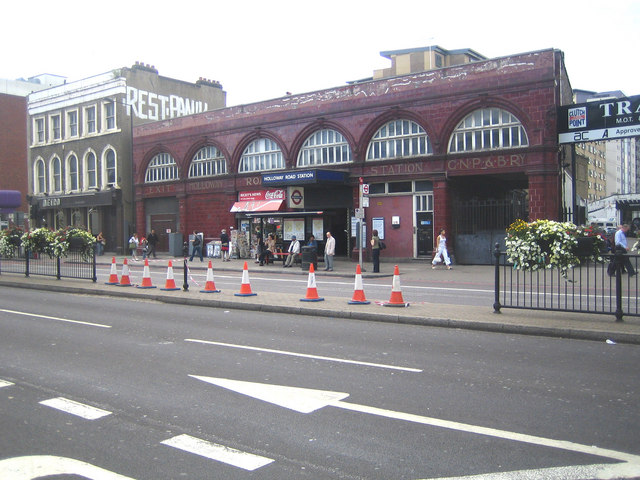 medium-sized maroon-painted station-entrance, formed as a series of six arches