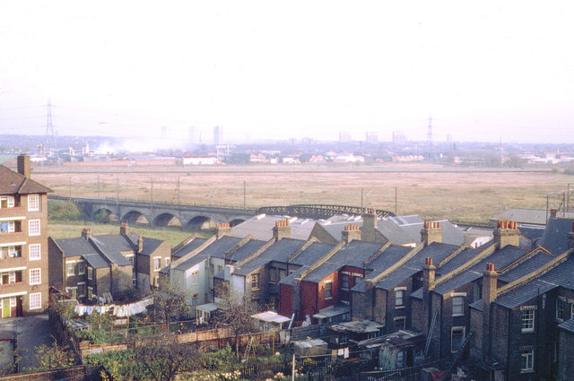 looking across small houses to an expanse of bare land