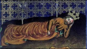 Mediaeval illumination showing a crowned king lying on a dark couch, his left hand under his head and a brown blanket over him, and a patterned blue and silver drape behind him