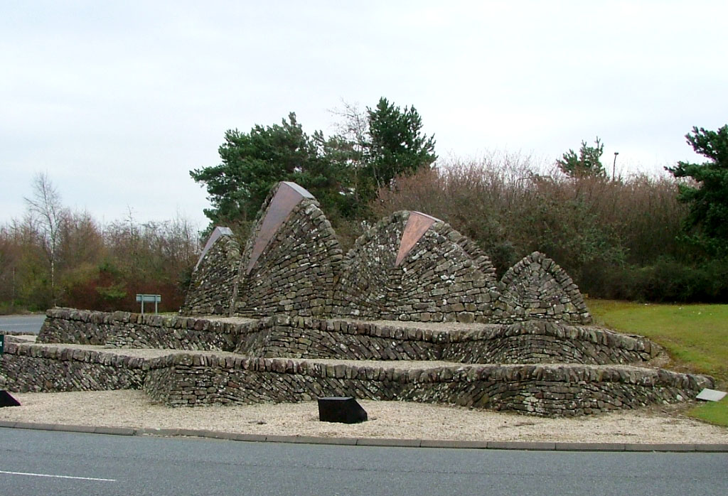 photo of roundabout decorated with humped stone walls with copper inserts