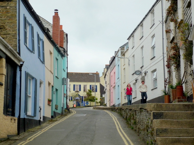Photo of sloping historic street with steps up to curb