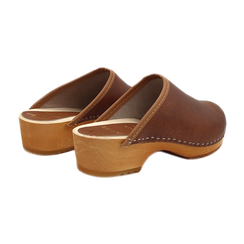 Photo of wood and brown leather clogs