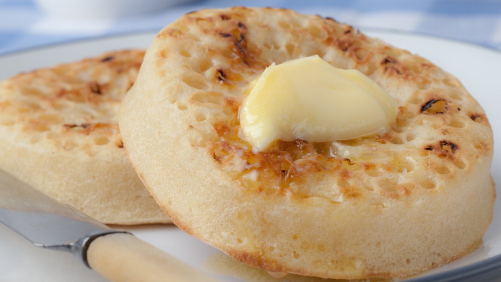 photo of two buttered muffins on a plate