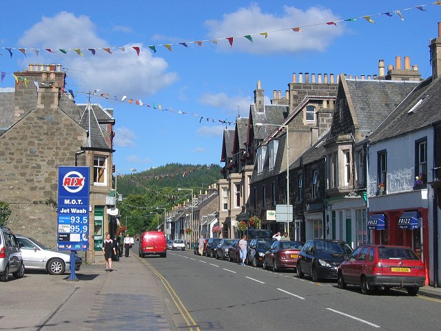view along a village high-street with an assortment of grey and white buildings