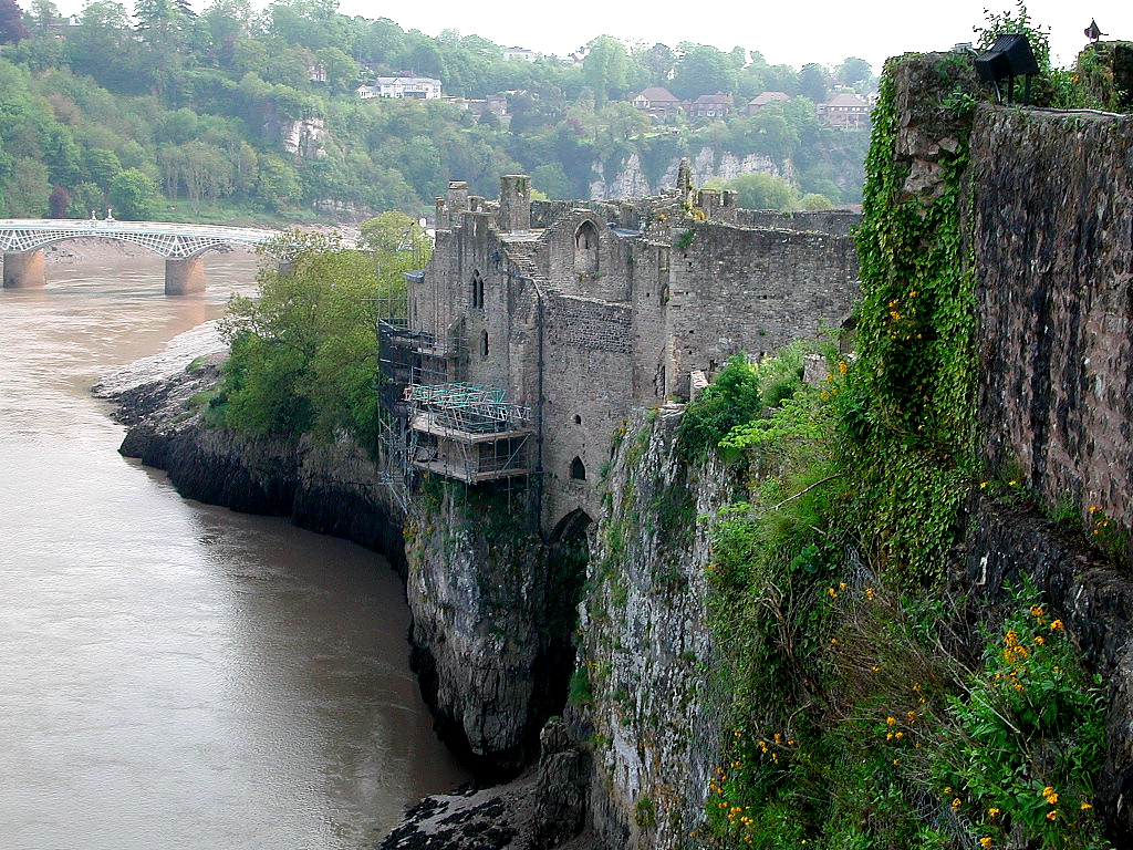 side of castle rising up from water, with channel going in under it