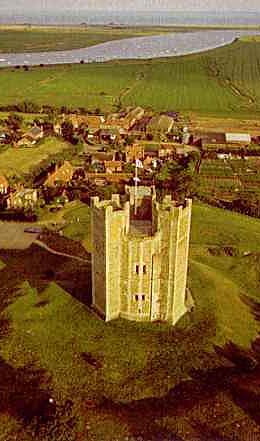 aerial photo\' of castle keep having a round central tower with three square towers sticking out from it in a triangular arrangement