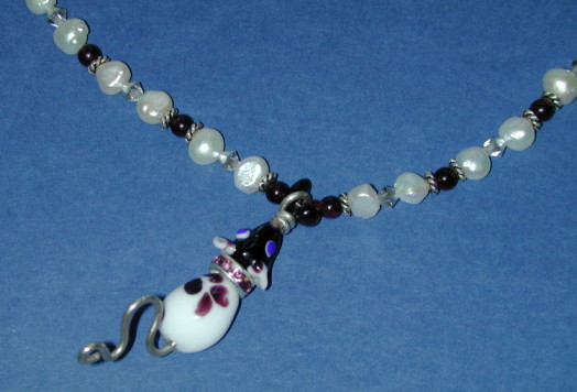 Photograph of rat-pendant made of glass beads