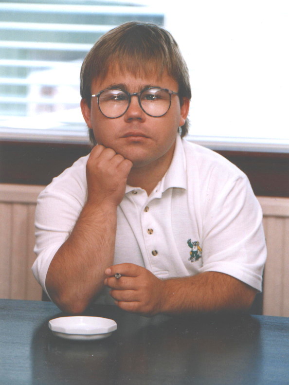 Full-face portrait of Eric Cullen, chin on hand