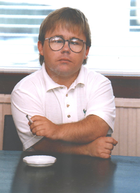 Full-face portrait of Eric Cullen, wreathed in cigarette smoke