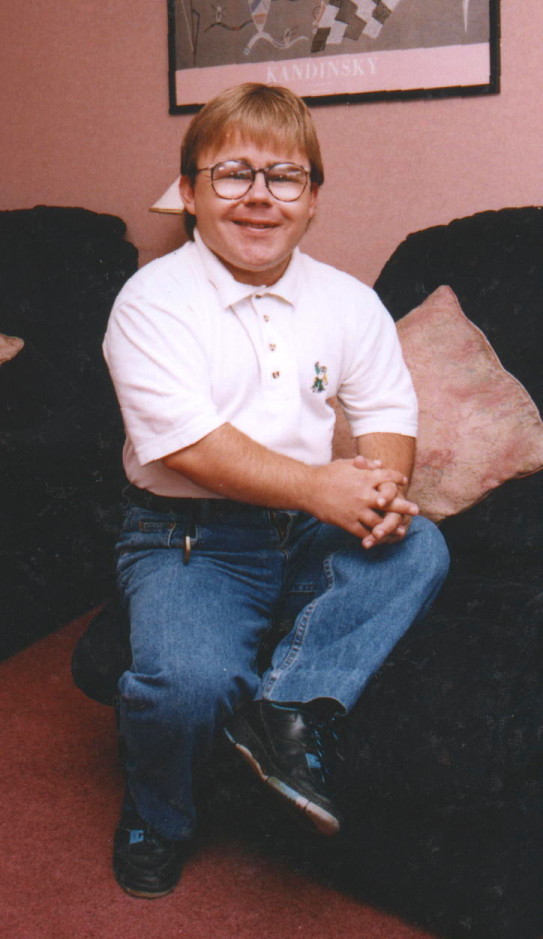 Eric Cullen on sofa, smiling