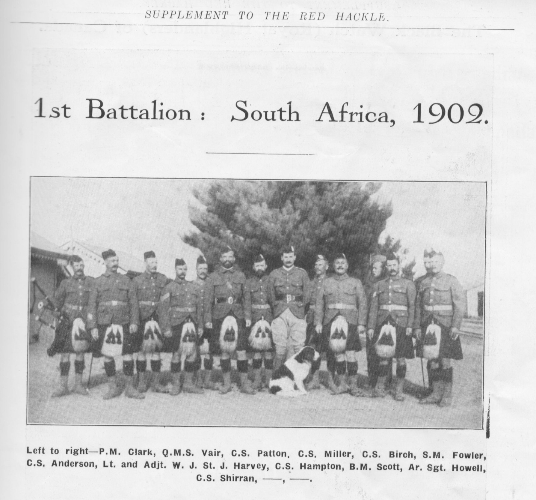 newspaper photo\' showing two rows of soldiers standing in kilts, flanking one in ill-fitting jodhpurs, with a black-and-white spaniel-type dog sitting at the front; the men are not all facing the camera, there seems to be some conversation going on at the back
