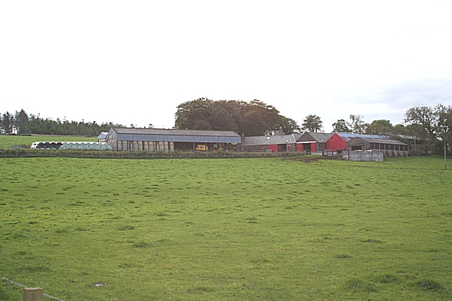 farm buildings on a low skyline across a green slope