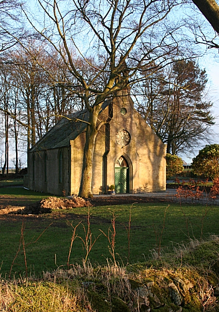 slightly disused small Victorian or Georgian church surrounded by bare trees