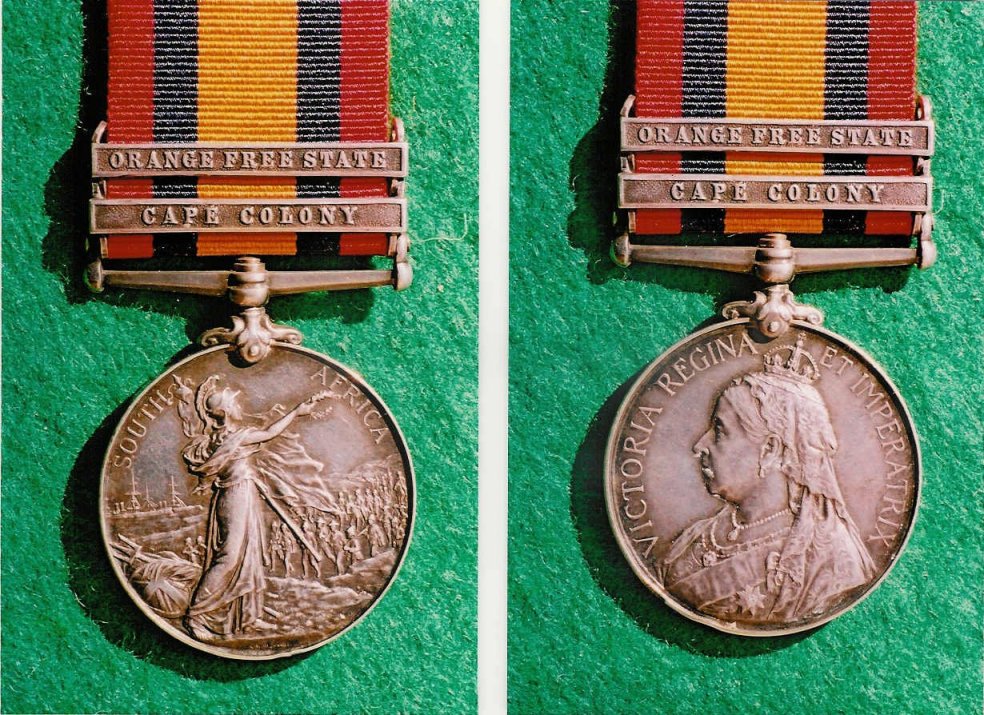 medal with Queen Victoria on one side and a standing Britannia on the other, with a ribbon having a wide orange stripe down the centre, flanked on either side by a thinner line of dark blue or black and another of bright red